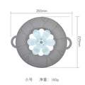 Silicone spill-proof pot cover in black, size 30x26cm, resting on a pot
