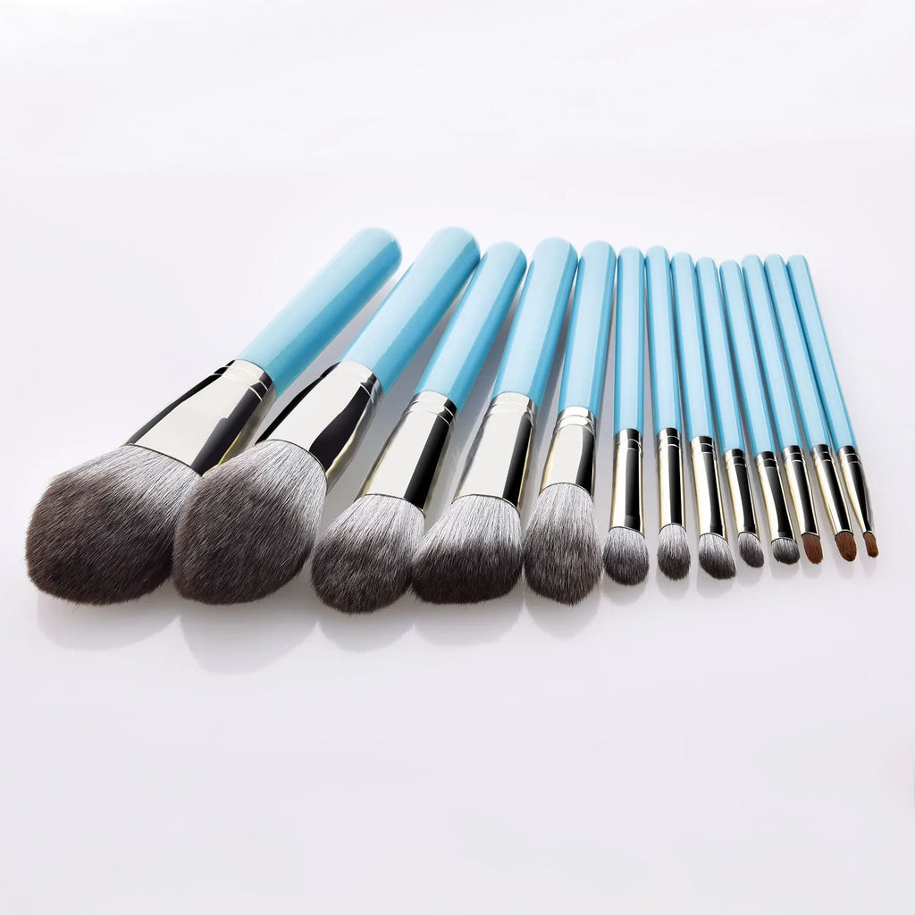 Blue 13-piece synthetic hair makeup brush set with wooden handles and aluminum ferrules on a clean surface