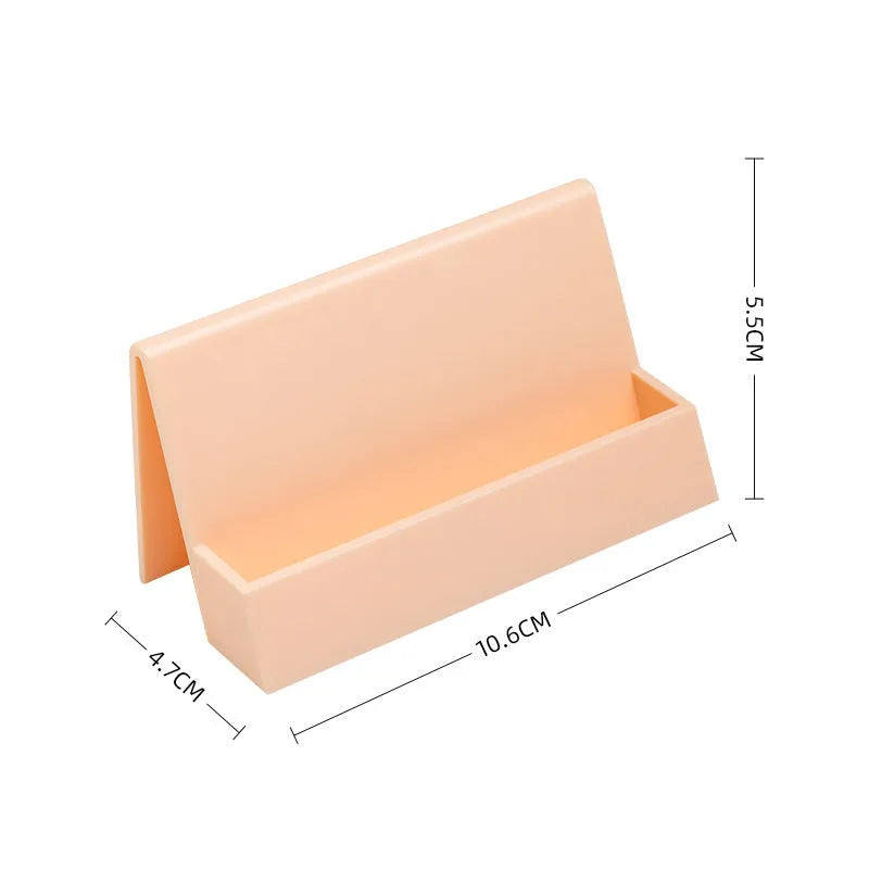 Creative PS geometric business card stand in brown, holding 20 cards upright on a desk.