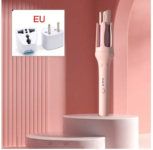 White and pink automatic hair curler with a 32mm ceramic barrel and a US plug adapter on a table.