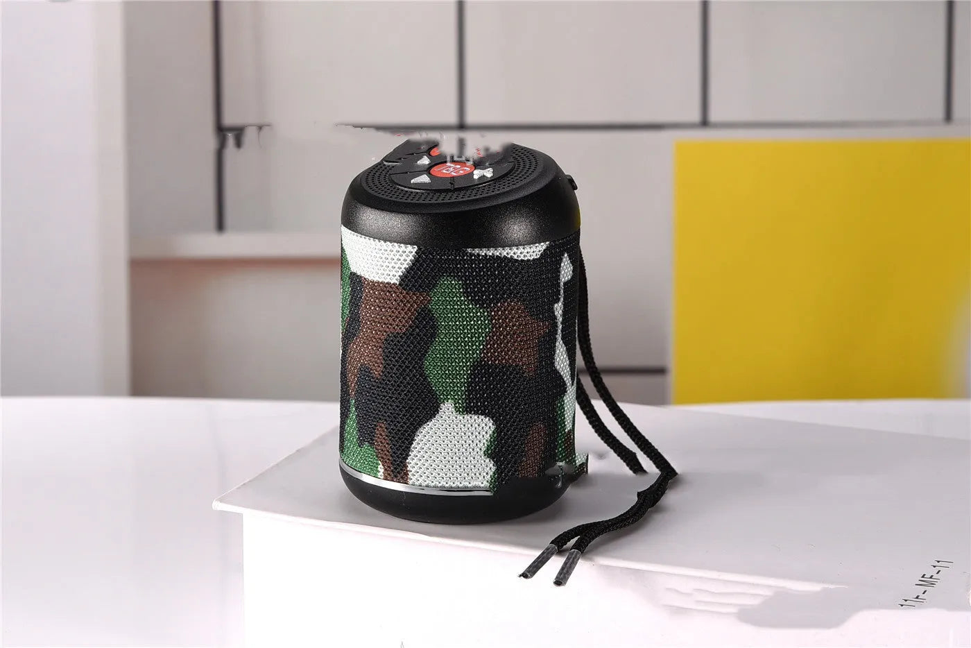 Portable outdoor Bluetooth subwoofer speaker in multiple colour options showing button controls.