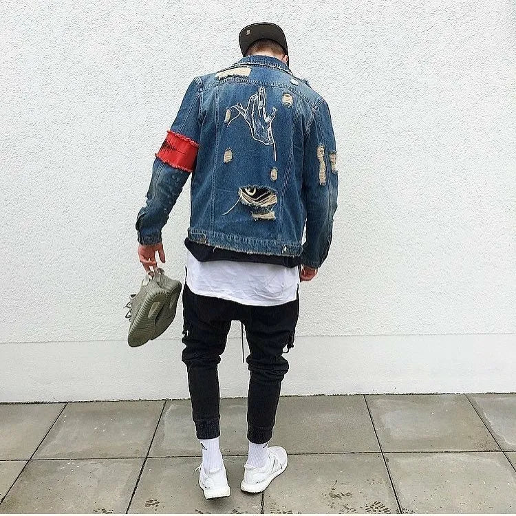 Blue embroidered cotton denim jacket for women on model, showing decorative stitching on front panels