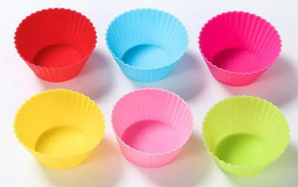 Twelve reusable silicone cupcake liners in six colours, two cups per colour, with a nonstick surface.