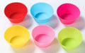 Twelve reusable silicone cupcake liners in six colours, two cups per colour, with a nonstick surface.