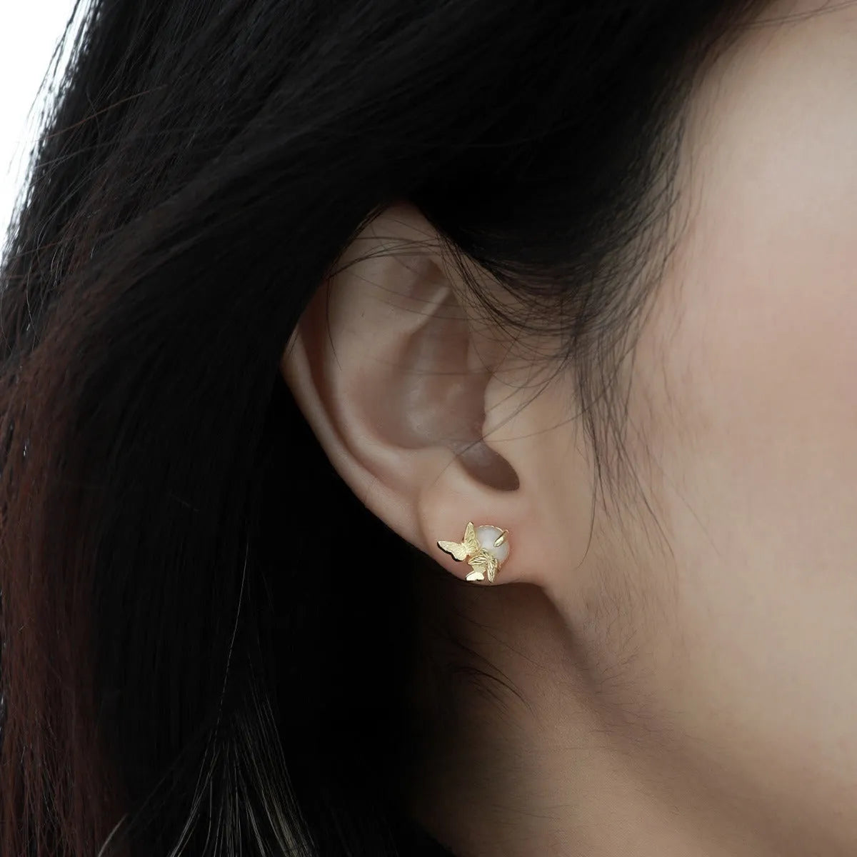 A pair of 925 silver butterfly ear studs with an electroplated finish in either white gold or gold colour.