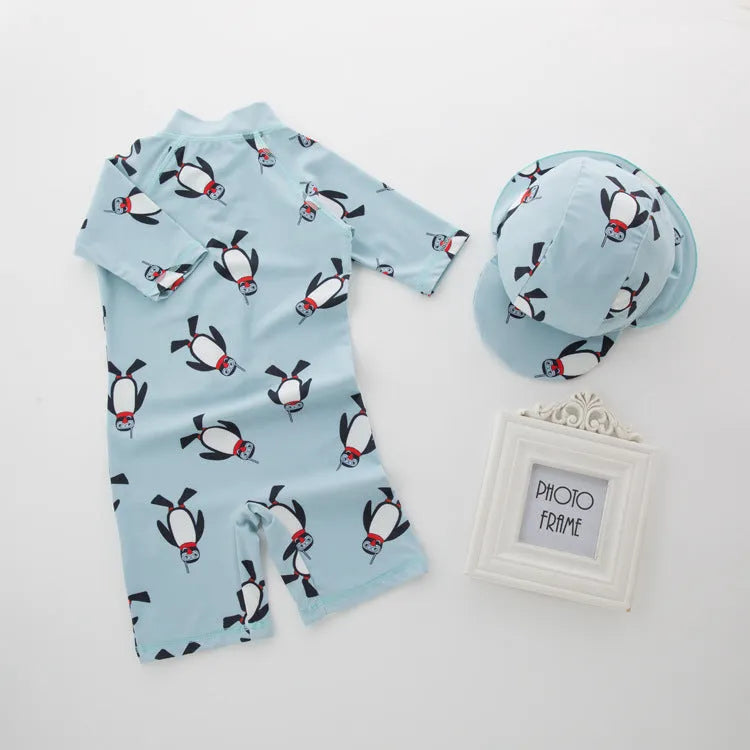 Boy's penguin print long sleeve swimsuit two-piece set with matching swim cap.