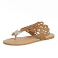 Women's black slip-on sandals with rhinestone detail across the toe and a flat rubber sole.