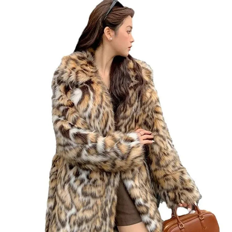 Long faux fur coat with a textured fox fur collar and side pockets.