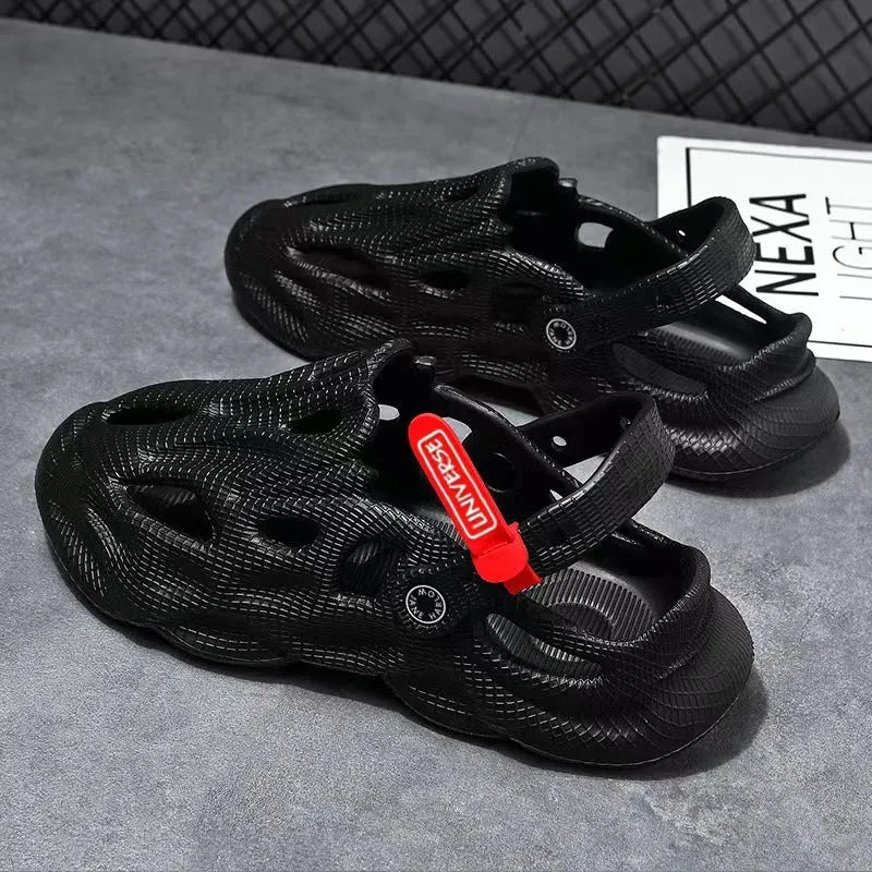 Men's grey EVA foam slippers with closed toe and thickened sole on a sandy beach.