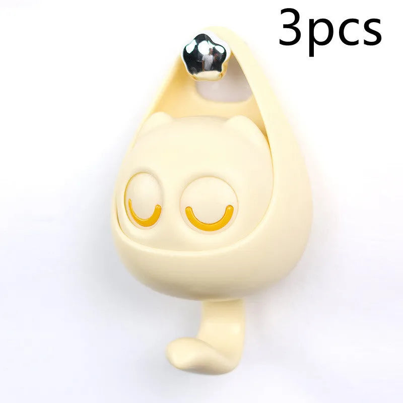 Cream white cat-shaped adhesive wall hook with winking eyes, 2.5kg capacity, 105x61x45mm