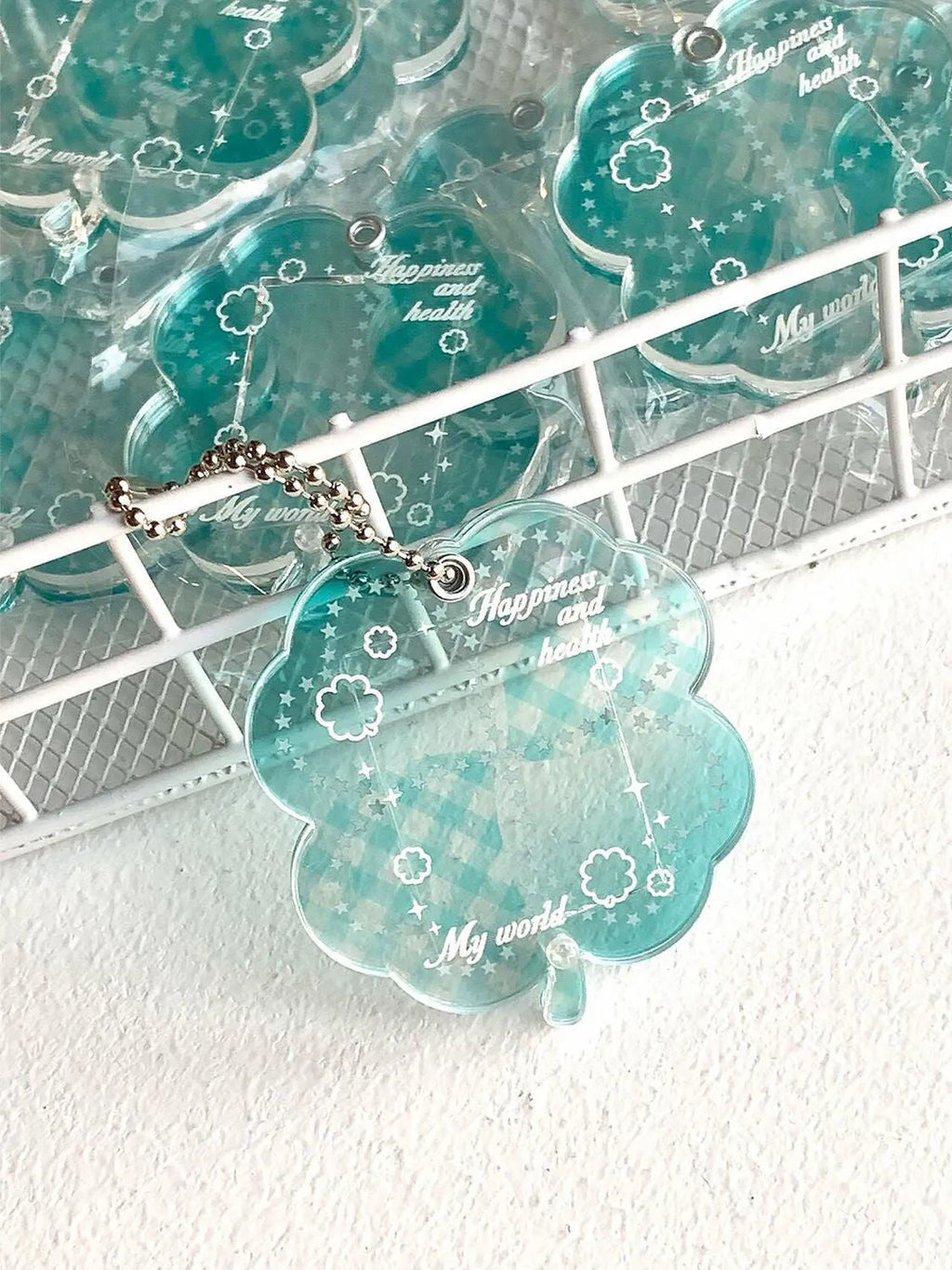 Acrylic four-leaf clover charm pendant keychain in blue, green, and mint colour options
