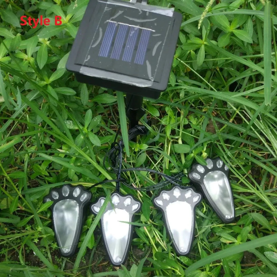 Black bear paw print solar garden light with integrated solar panel pole