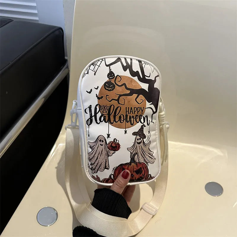 Black mini crossbody bag with Halloween cartoon print of pumpkins, ghosts, and bats.