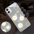 White iPhone case with painted purple daisy design and illuminated multi-colour LED lights around the edges.