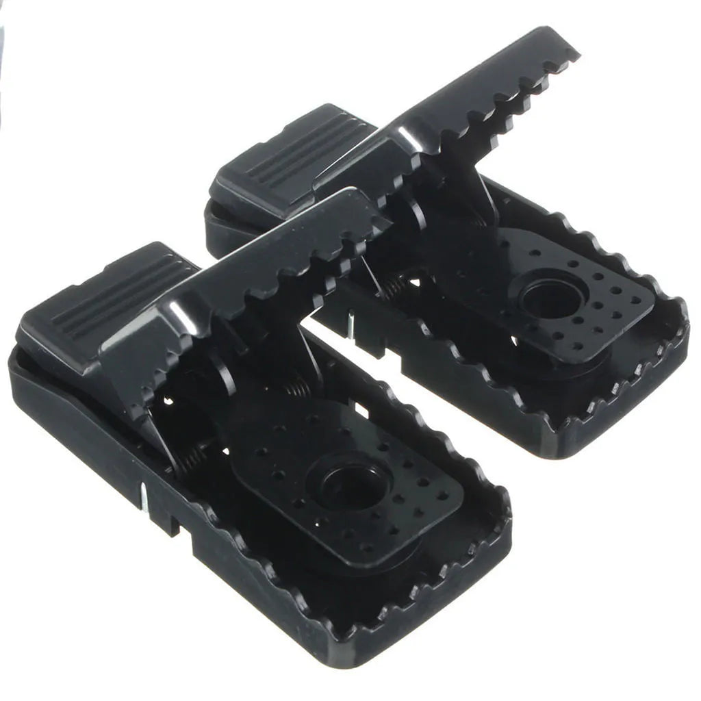 Six black plastic snapping mousetraps with metal trigger, shown on a white background.
