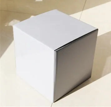 Square corrugated cardboard packaging box in black, brown, grey, and white colour options on a white background.