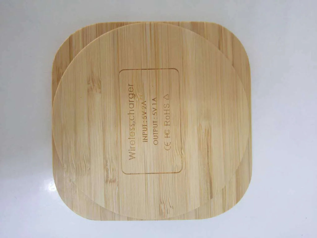 Square wooden bamboo 5W wireless charging pad on a table.