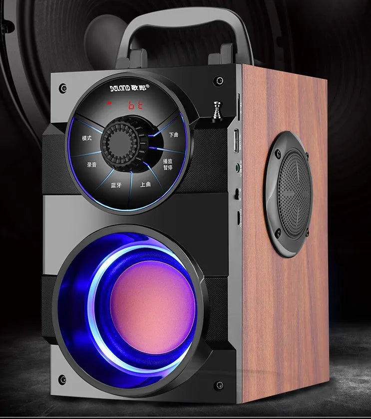 Black portable mini audio system with subwoofer and a 1.2m connection cable on a desk.