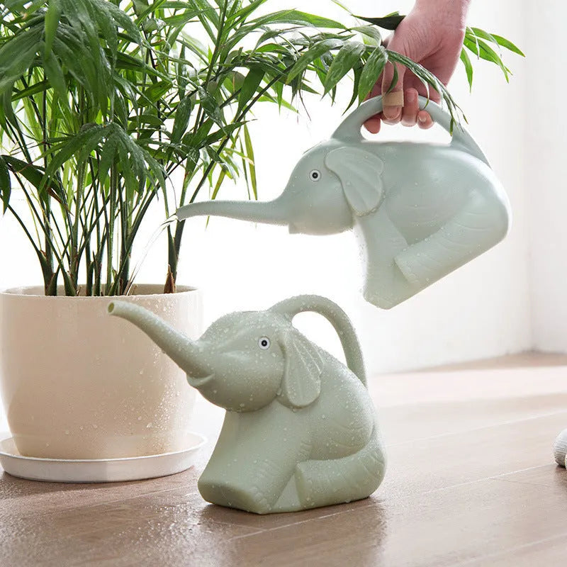 Pink elephant-shaped children's watering can with a long nozzle for gardening.
