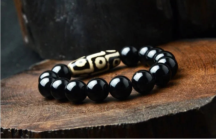 Natural black agate bracelet with nine eyes beads on neutral background, three size options 10mm 12mm 14mm