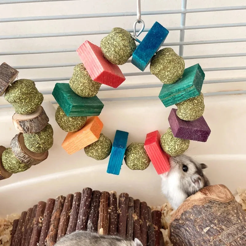Hamster toy set showing decorative straw ball rings and applewood molar bite rod for small animal enrichment