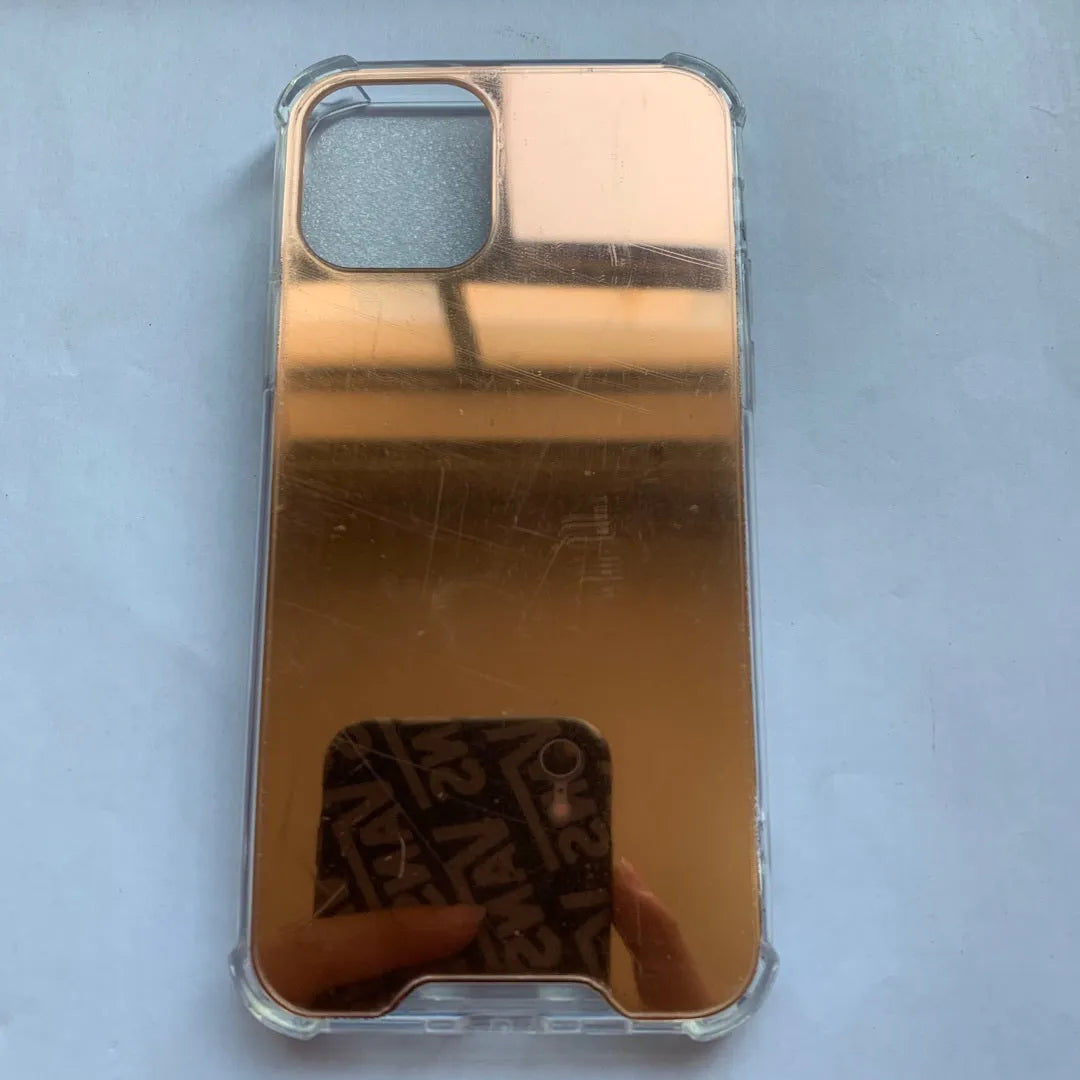 TPU mirror phone case for iPhone on a table, showing anti-fingerprint finish.