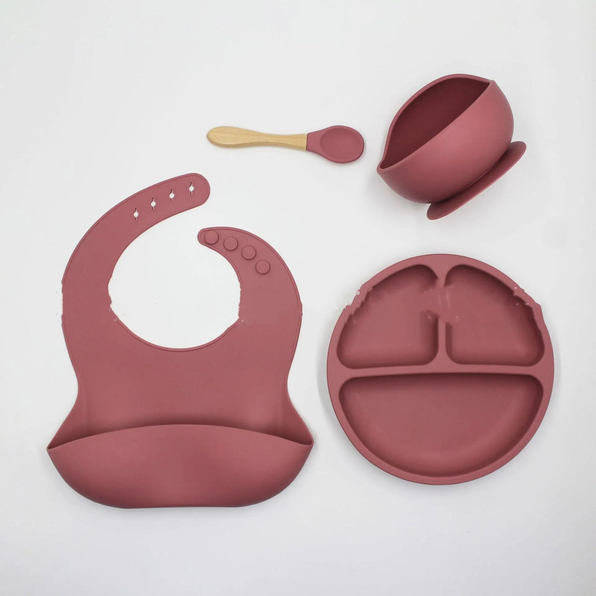 4 piece food grade silicone baby feeding set with bib, plate, bowl, and spoon in dark grey, khaki, or rose red