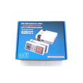 Compact black NES 8-bit retro game console with two controllers on a table