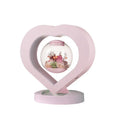 Pink preserved rose ornament with LED lights, shown with and without a decorative base.