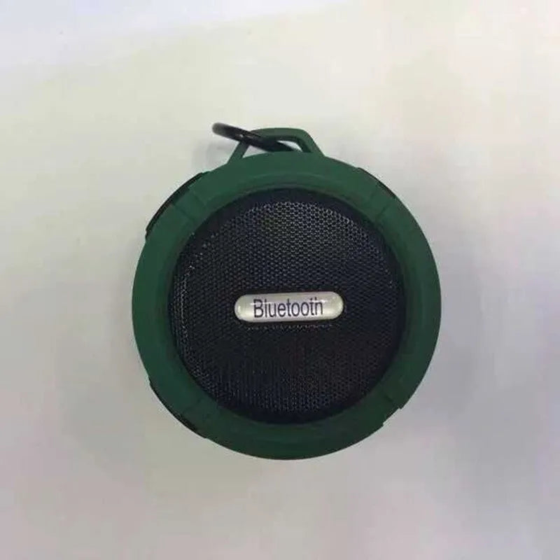 Waterproof portable Bluetooth mini speaker in black, blue, green, red, or yellow with a mountaineering buckle.