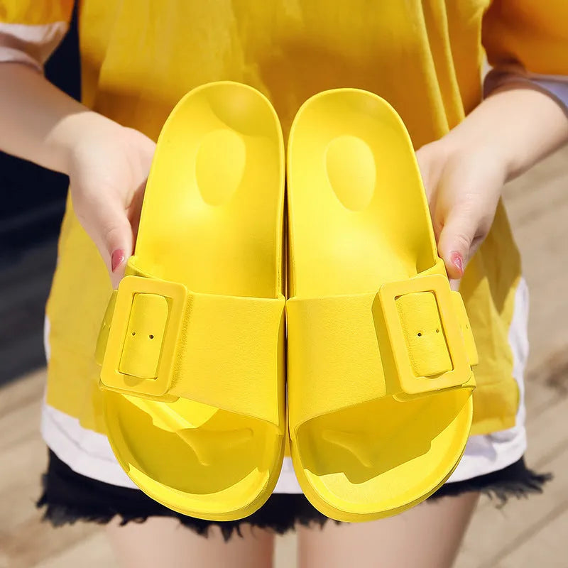 Women's grey blue EVA foam slippers with a buckle strap and soft sole.