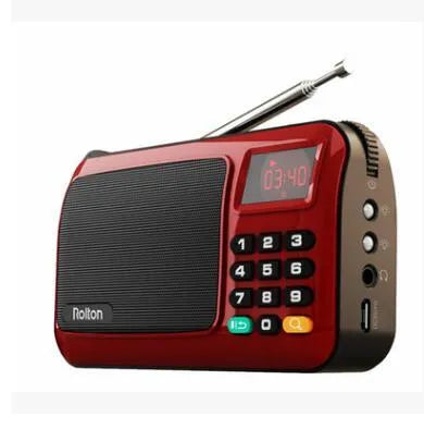 Golden Rolton W405 portable FM radio and MP3 speaker with LED display on a textured surface.