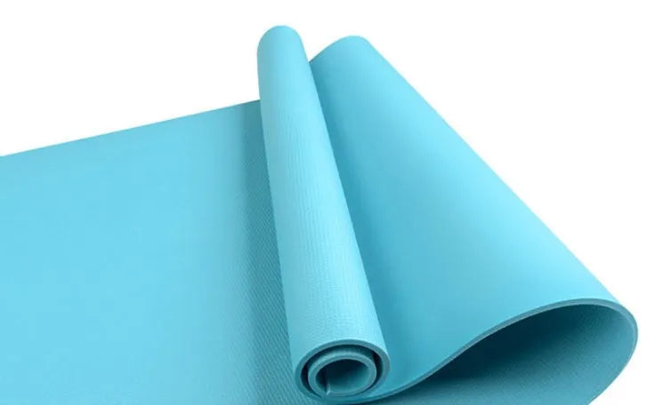 Red EVA fitness composite yoga mat with rolled edge showing 4mm thickness on a wooden floor.