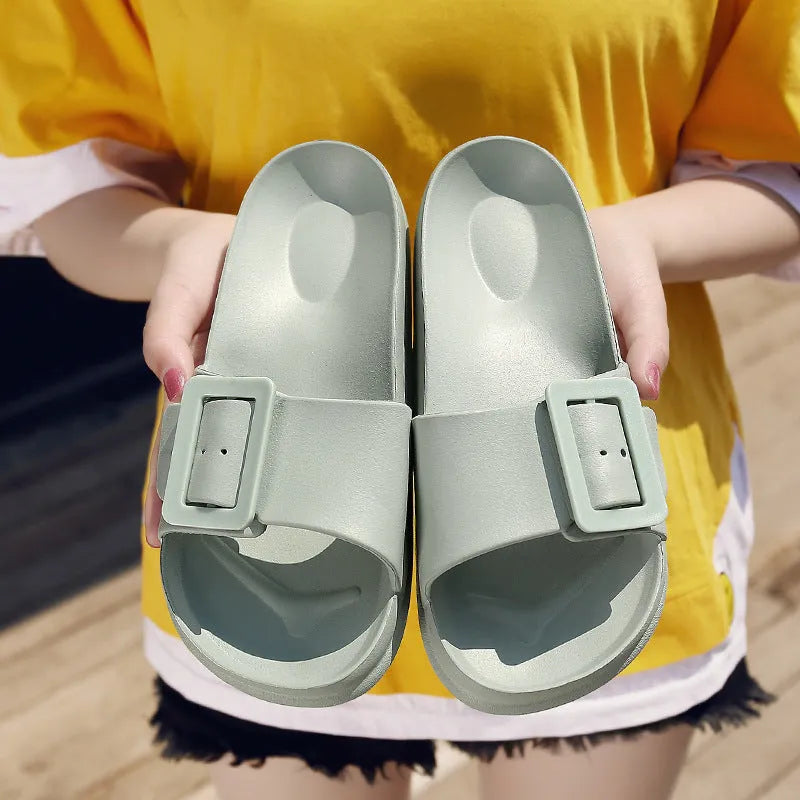 Women's grey blue EVA foam slippers with a buckle strap and soft sole.