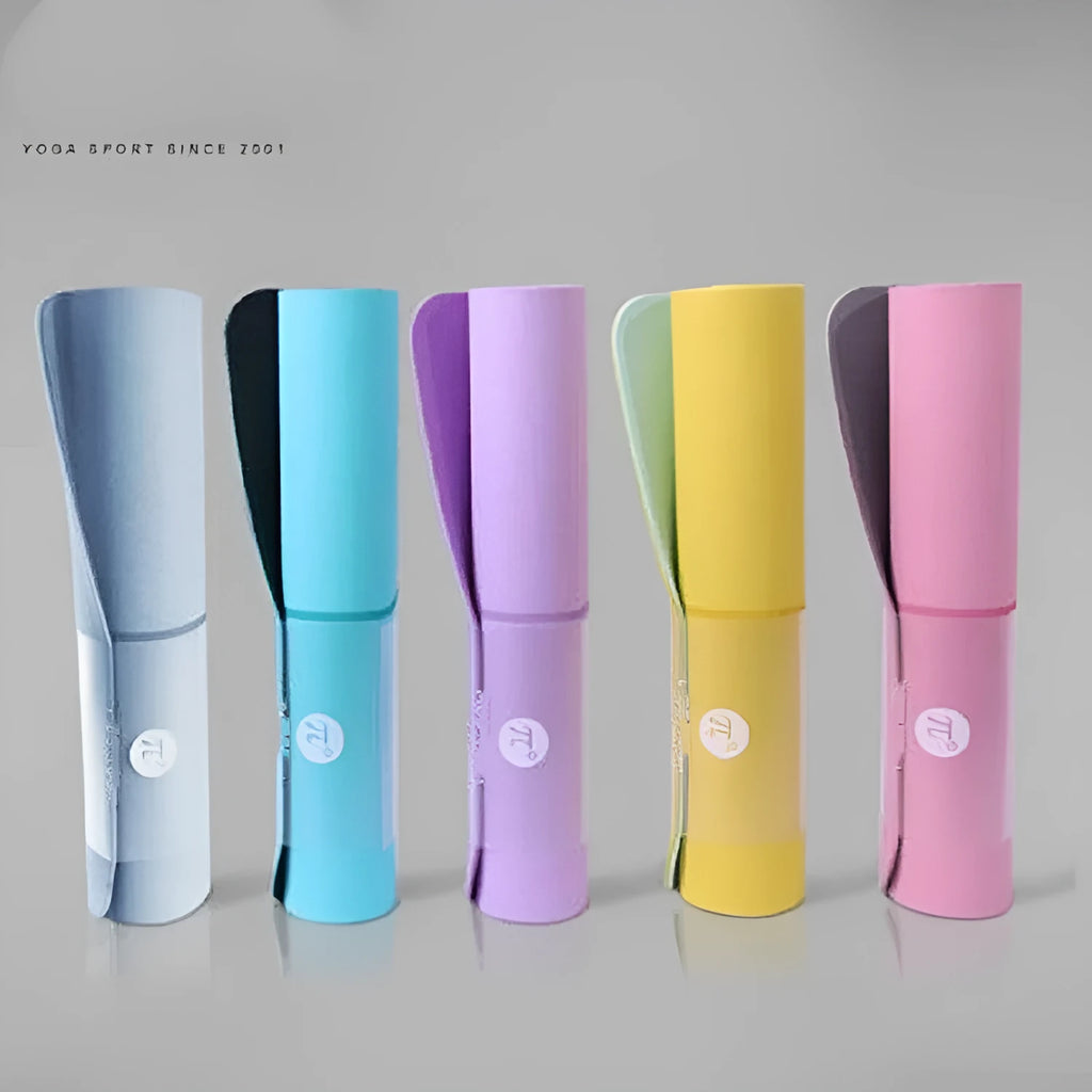 Paido TPE yoga mat in Pink Grey colour rolled out on a wooden floor with a yoga block nearby