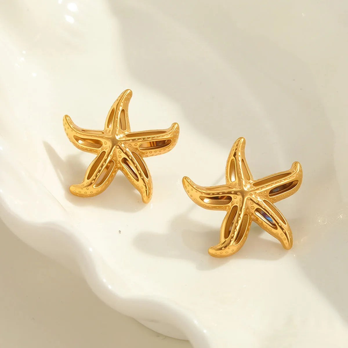 Gold-toned stainless steel stud earrings with starfish and star motifs, colour NMSE-J725-3