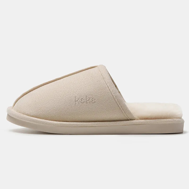Pair of warm plush cotton slippers with TPR sole in beige on a tiled floor