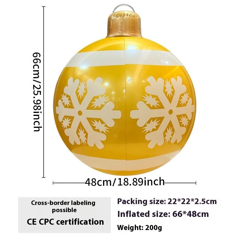 Large red and white inflatable Christmas ball with flashing lights standing in a garden.