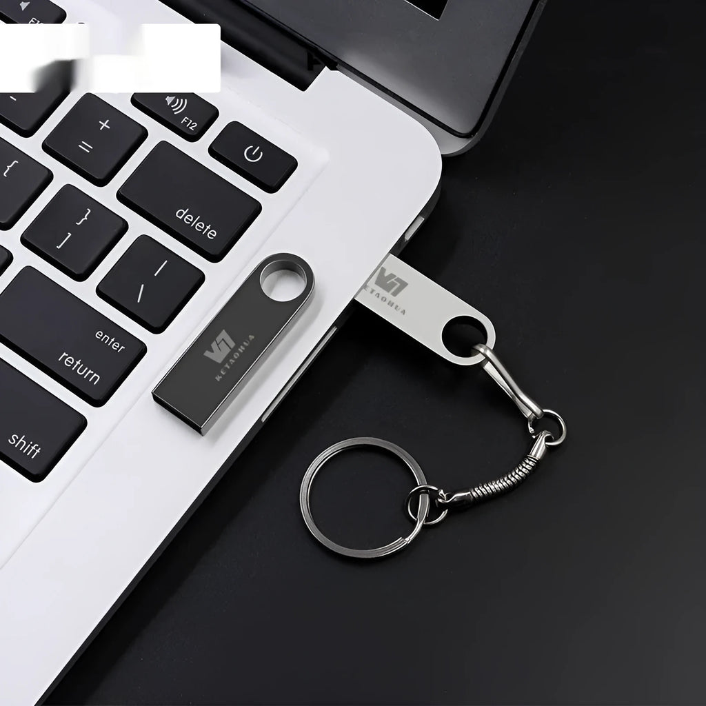 Silver metal car-shaped USB flash drive on a white background showing its compact size and detailed design.