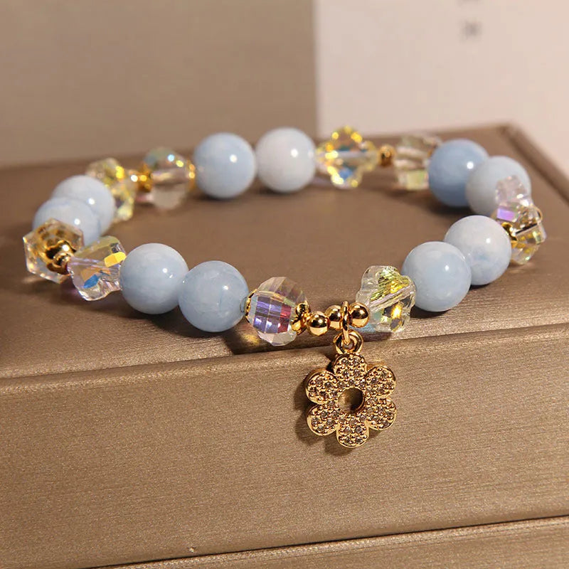 Aquamarine crystal bracelet with a four-leaf clover charm and pearl details for women.