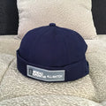 Cotton baseball cap with adjustable buckle in black showing letter pattern and rivet details
