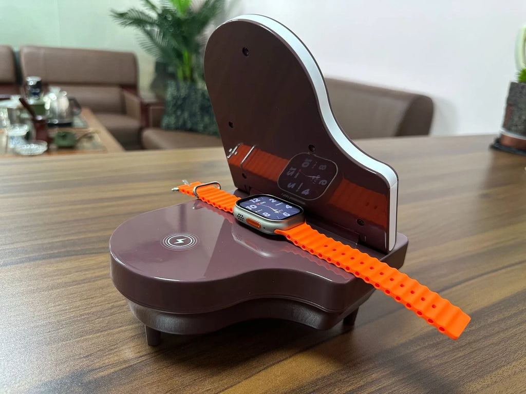 Black multi-function Bluetooth speaker wireless charger and phone holder on a desk