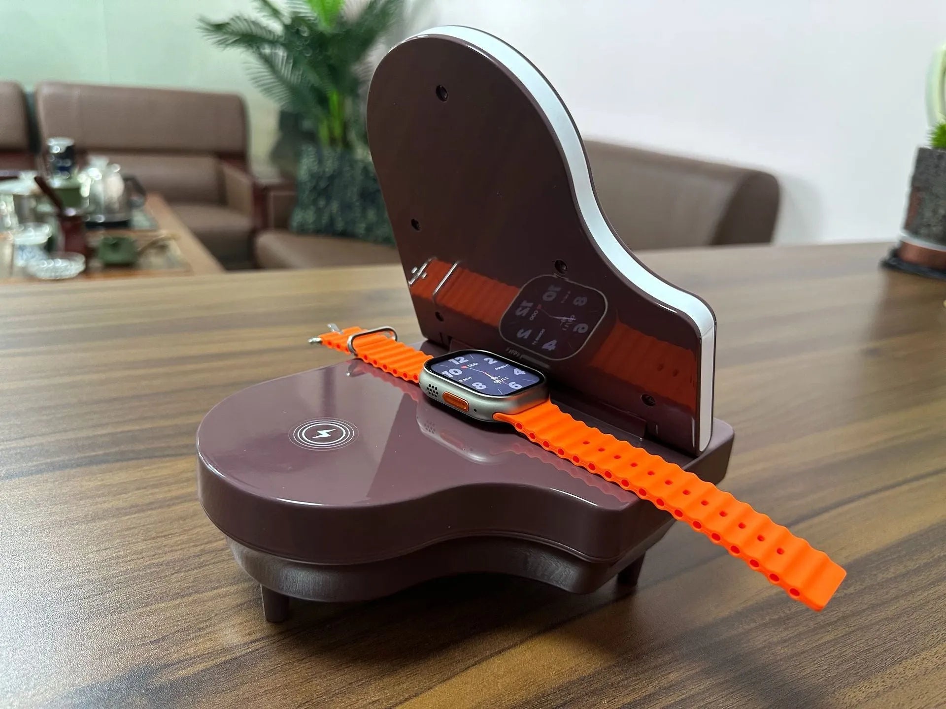 Black multi-function Bluetooth speaker wireless charger and phone holder on a desk