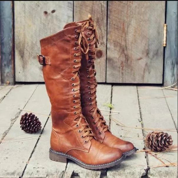 Black women's high leg boots with a low chunky heel and round toe made from artificial PU.