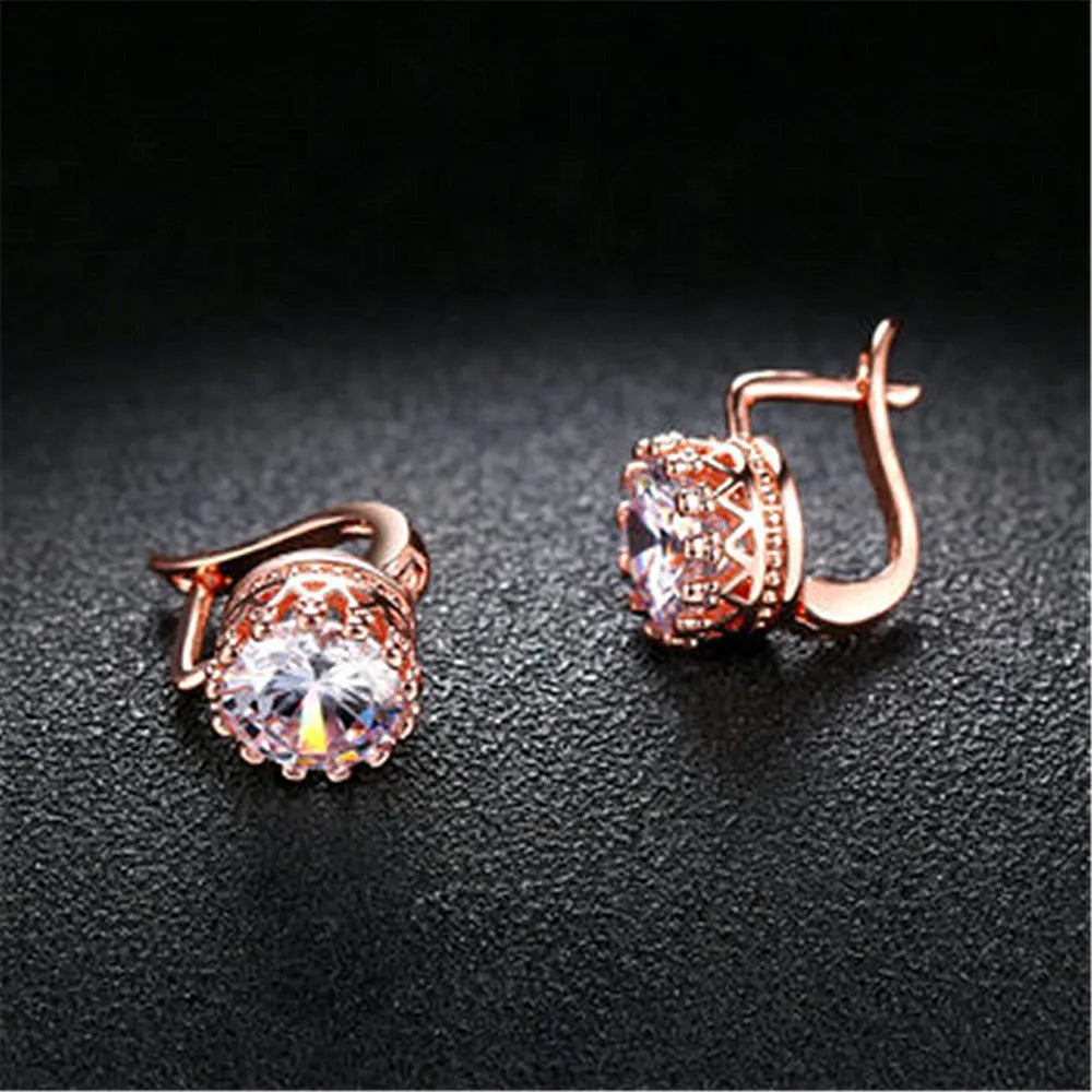 A pair of Korean retro crown-shaped clip-on earrings with a white diamond centre, in a rose gold finish.