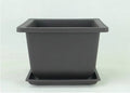 Dark brown antique-style recycled plastic plant pot, shown in a selection of sizes for desktop or floor use.