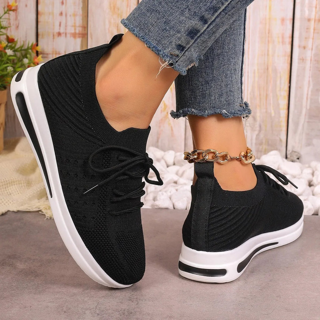 Women's low top casual sneakers in red, featuring a fly-knit upper and front lace-up fastening.
