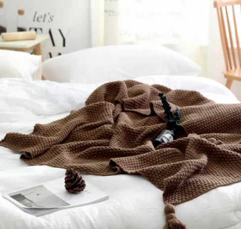 Nordic fringed knit ball acrylic throw blanket in beige on sofa, 130x170cm size