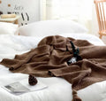 Nordic fringed knit ball acrylic throw blanket in beige on sofa, 130x170cm size