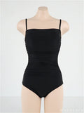 Women's sling style one-piece swimsuit with belly pleating in solid colour.
